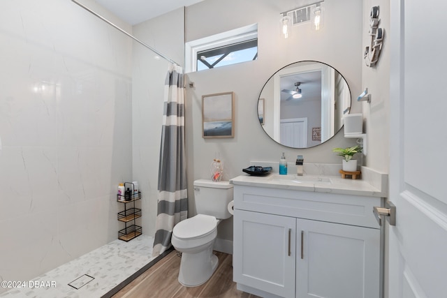 bathroom featuring hardwood / wood-style floors, a shower with curtain, and toilet