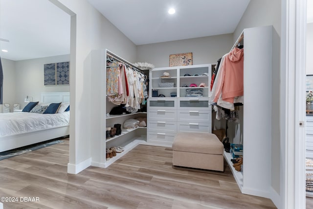 walk in closet with light wood-type flooring