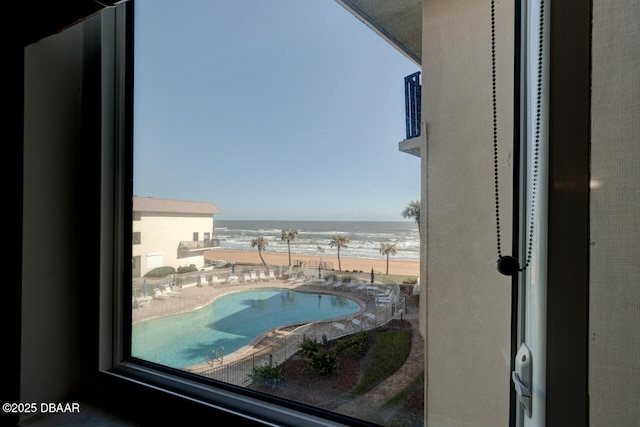 interior space with a view of the beach and a water view