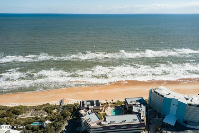 drone / aerial view featuring a water view and a beach view