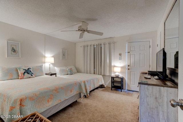 carpeted bedroom featuring ceiling fan and a textured ceiling