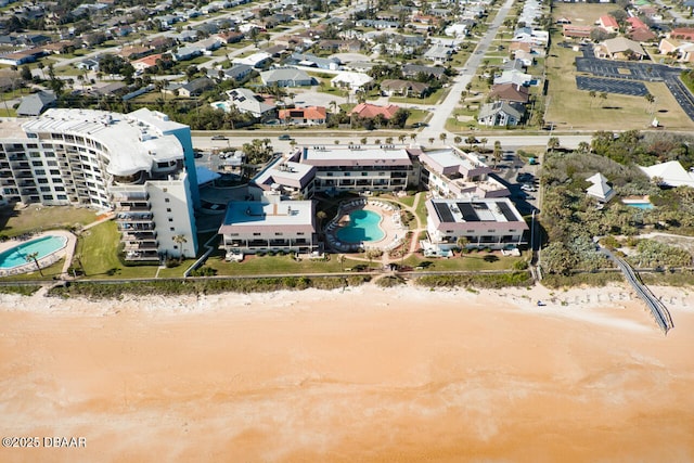 birds eye view of property with a water view and a view of the beach