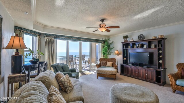 carpeted living room featuring a textured ceiling, ceiling fan, and crown molding