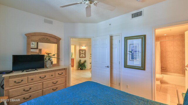 tiled bedroom with connected bathroom and ceiling fan