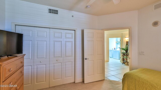 bedroom with a closet and light colored carpet