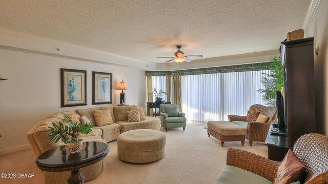 carpeted living room with a textured ceiling, ceiling fan, and ornamental molding