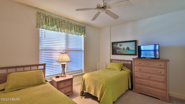 bedroom featuring ceiling fan and light carpet