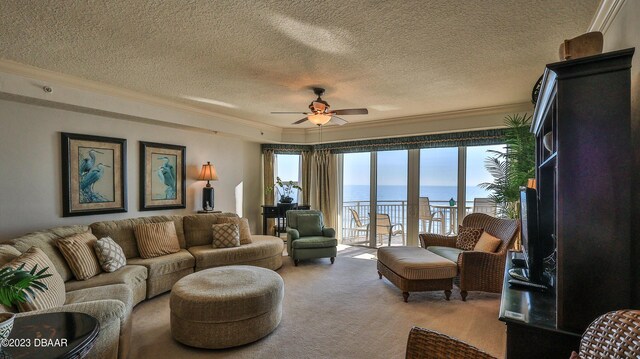 living room with carpet, a textured ceiling, plenty of natural light, and ornamental molding