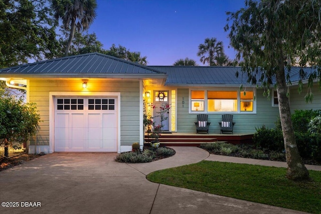 101 Azalea Cir, New Smyrna Beach, FL 32168 - single story home with concrete driveway, a metal roof, a garage, and covered porch