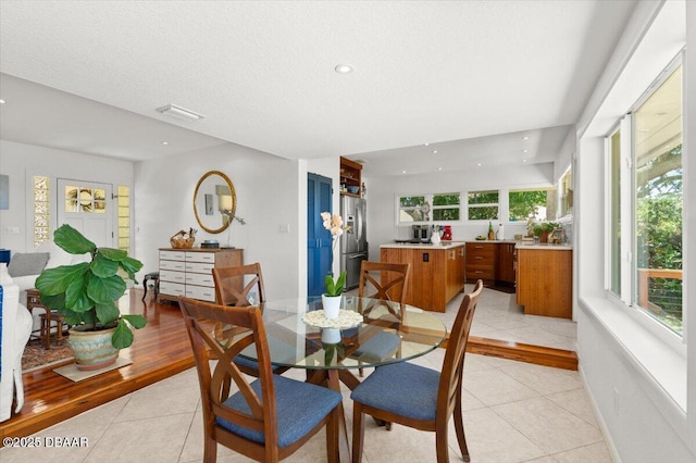 101 Azalea Cir, New Smyrna Beach, FL 32168 - dining area with light tile patterned floors and recessed lighting