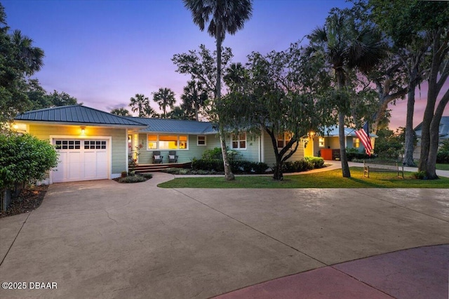 101 Azalea Cir, New Smyrna Beach, FL 32168 - view of front of house featuring driveway, a garage, a metal roof, and a lawn