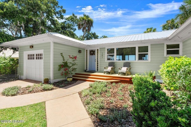 101 Azalea Cir, New Smyrna Beach, FL 32168 - view of front of home featuring a metal roof and a garage
