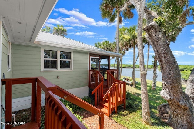 101 Azalea Cir, New Smyrna Beach, FL 32168 - wooden deck with a water view and a lawn