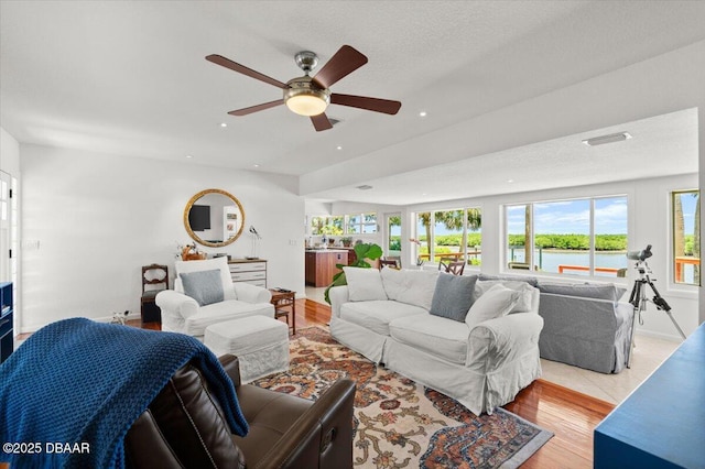101 Azalea Cir, New Smyrna Beach, FL 32168 - living room featuring a ceiling fan, light wood-type flooring, recessed lighting, and a water view