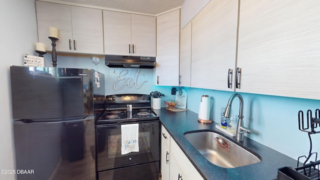 kitchen with dark countertops, a sink, a textured ceiling, under cabinet range hood, and black appliances