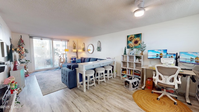 living area with a textured ceiling and wood finished floors