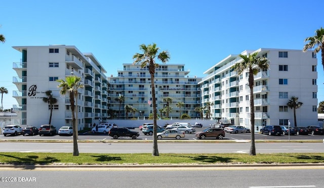 view of building exterior with uncovered parking