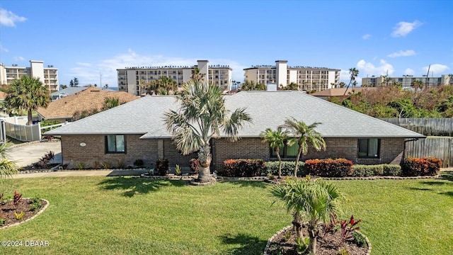 22 Upper Cay Dr, Ormond Beach, FL 32176 - view of front of house featuring brick siding, a front yard, and roof with shingles
