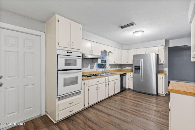 kitchen with dark hardwood / wood-style floors, white cabinetry, sink, and appliances with stainless steel finishes