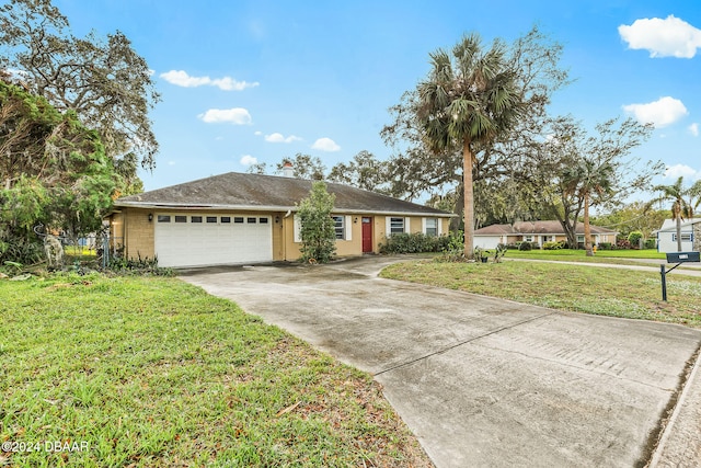 single story home featuring a front lawn and a garage