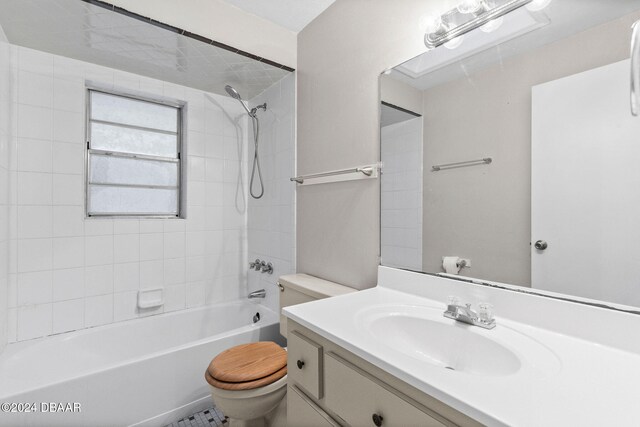 full bathroom featuring vanity, toilet, and tiled shower / bath