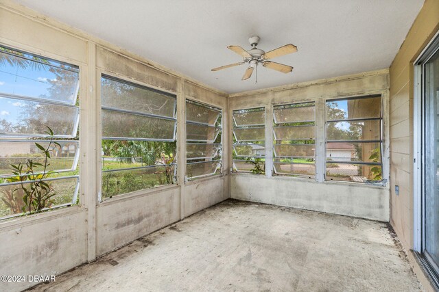 unfurnished sunroom featuring ceiling fan