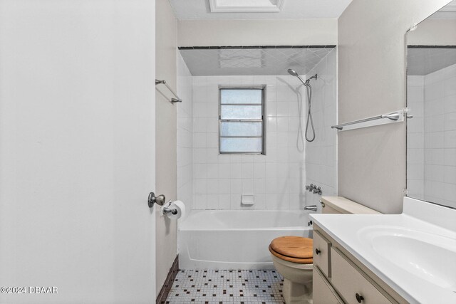 full bathroom featuring tile patterned flooring, vanity, toilet, and tiled shower / bath