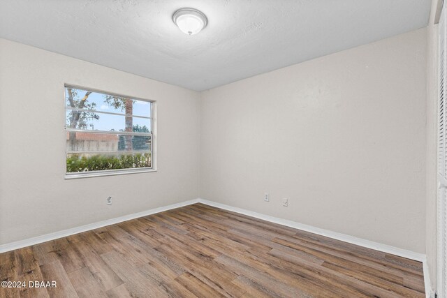 spare room with hardwood / wood-style floors