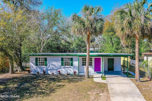 view of front of home featuring concrete driveway and fence