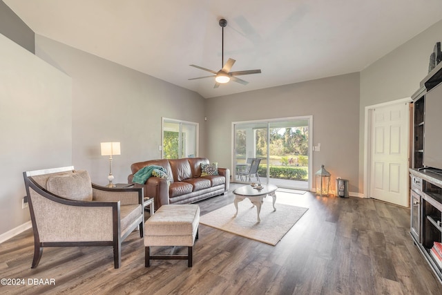 living room with ceiling fan, dark wood-type flooring, and lofted ceiling