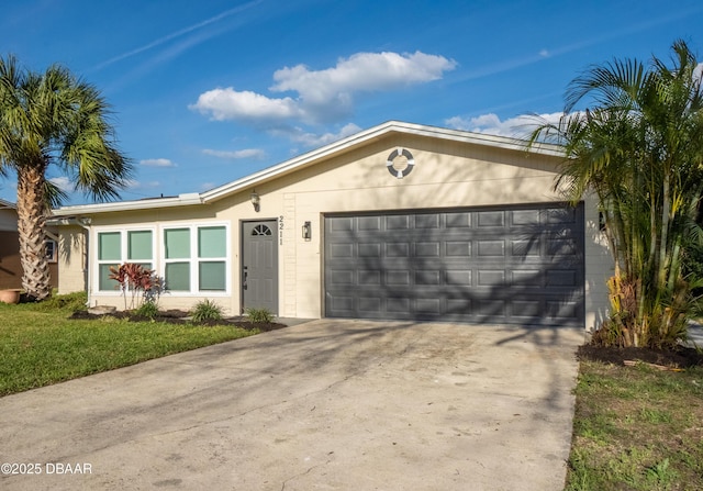 ranch-style house with a garage and a front lawn