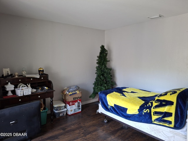 bedroom featuring dark wood finished floors and visible vents