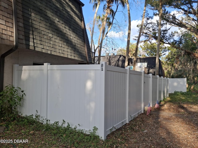 view of side of home featuring fence