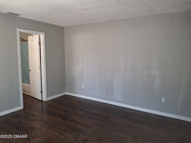81 Springwood Sq, Port Orange, FL 32129 - spare room featuring dark wood finished floors, a textured ceiling, and baseboards