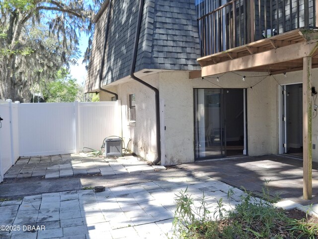 exterior space with fence and a balcony