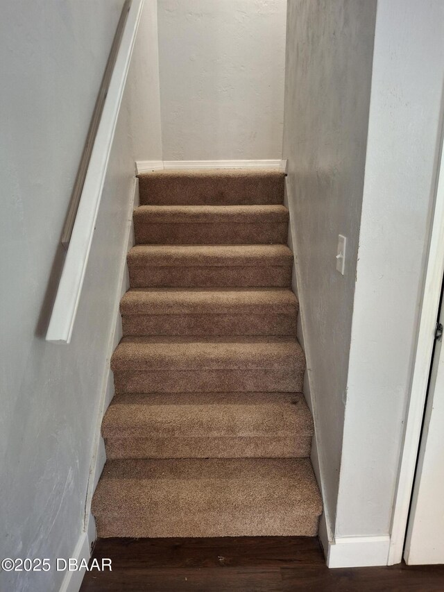 staircase with wood finished floors