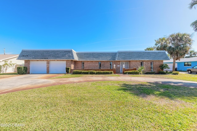 view of front of property with a garage, driveway, mansard roof, a front lawn, and brick siding