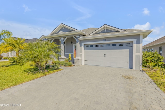 view of front facade featuring a garage and a front lawn