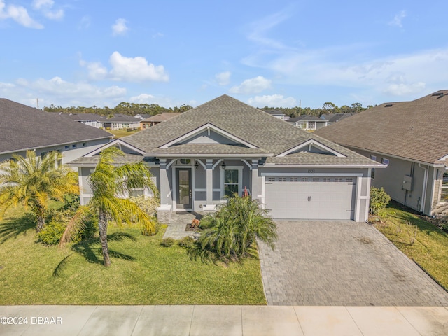 view of front of home with a garage and a front yard