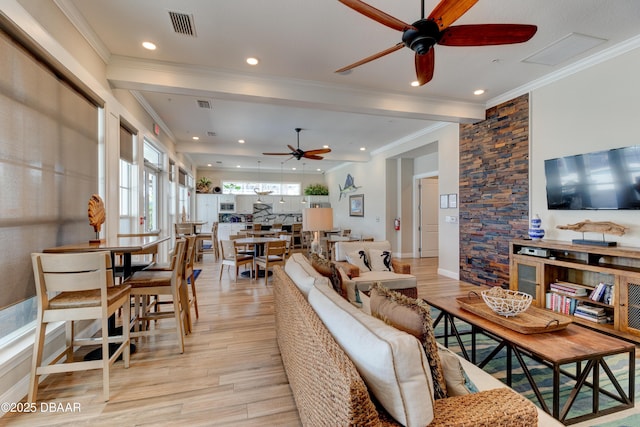 living room featuring light wood finished floors, recessed lighting, visible vents, and crown molding