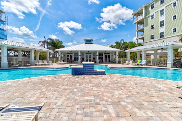 pool with a gazebo, a patio, and fence