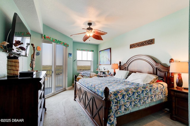 carpeted bedroom featuring baseboards, a ceiling fan, and access to exterior