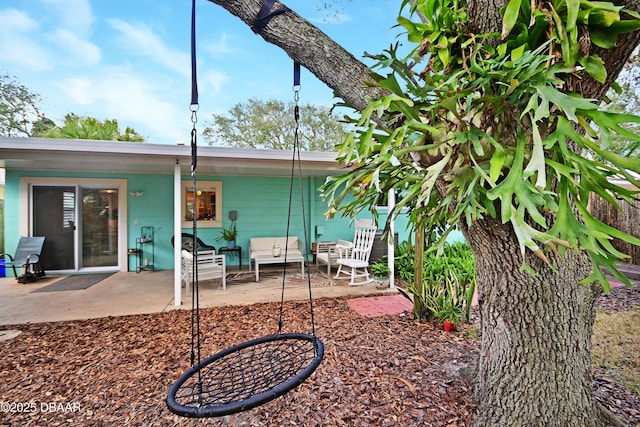 rear view of property featuring a patio