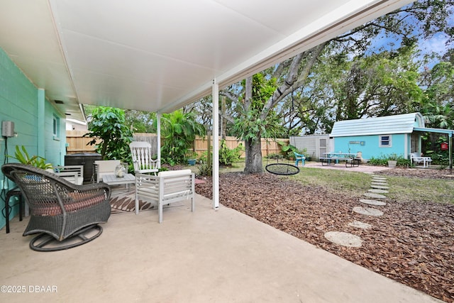 view of patio featuring a storage unit and an outdoor living space