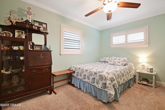 carpeted bedroom featuring crown molding and ceiling fan