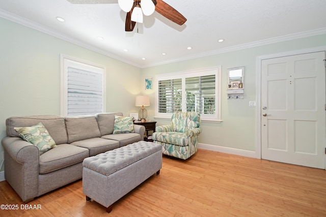 living room featuring ceiling fan, ornamental molding, and light hardwood / wood-style flooring