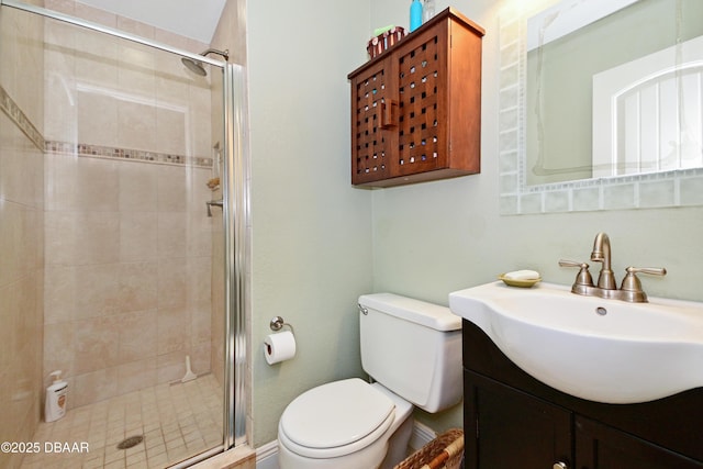 bathroom with walk in shower, vanity, and toilet