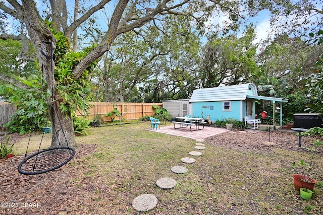 view of yard with a storage unit and a patio area