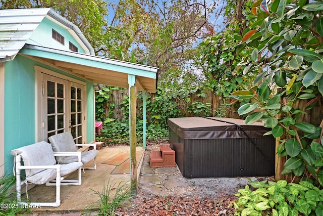 view of patio / terrace featuring a hot tub and french doors