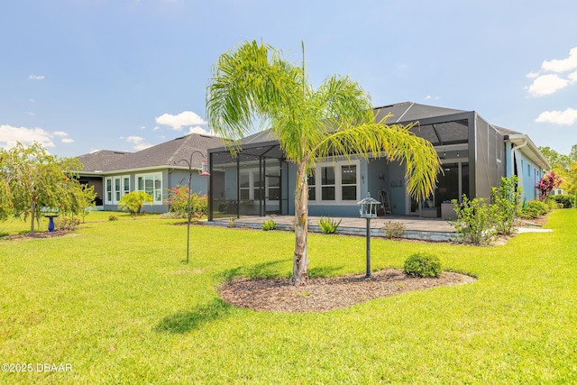 557 Mosaic Blvd, Daytona Beach, FL 32124 - back of property with a lawn, glass enclosure, and a patio
